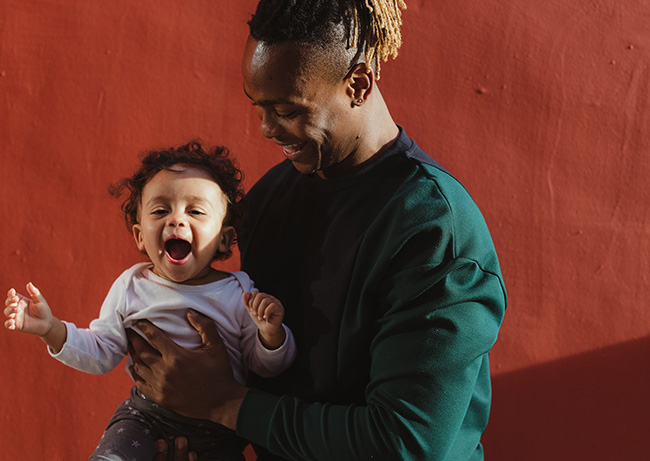 Man holding child laughing
